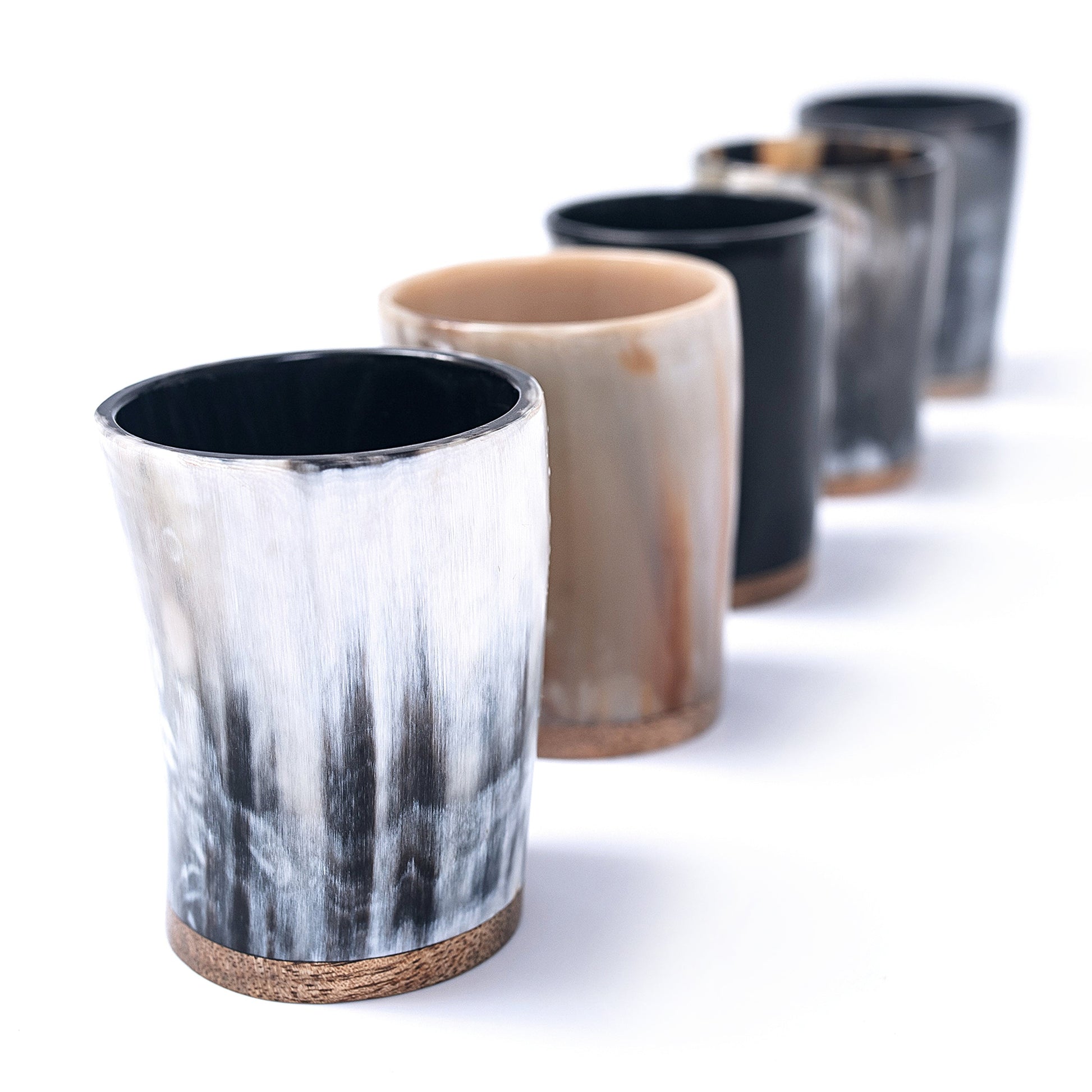 Set of horn cups with natural patterns on a white background