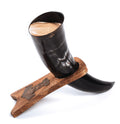 Black horn cup with wooden holder on a white background