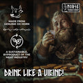 Man in Viking attire holding a drink with Norse Tradesman branding and text about ox horn drinking vessels.