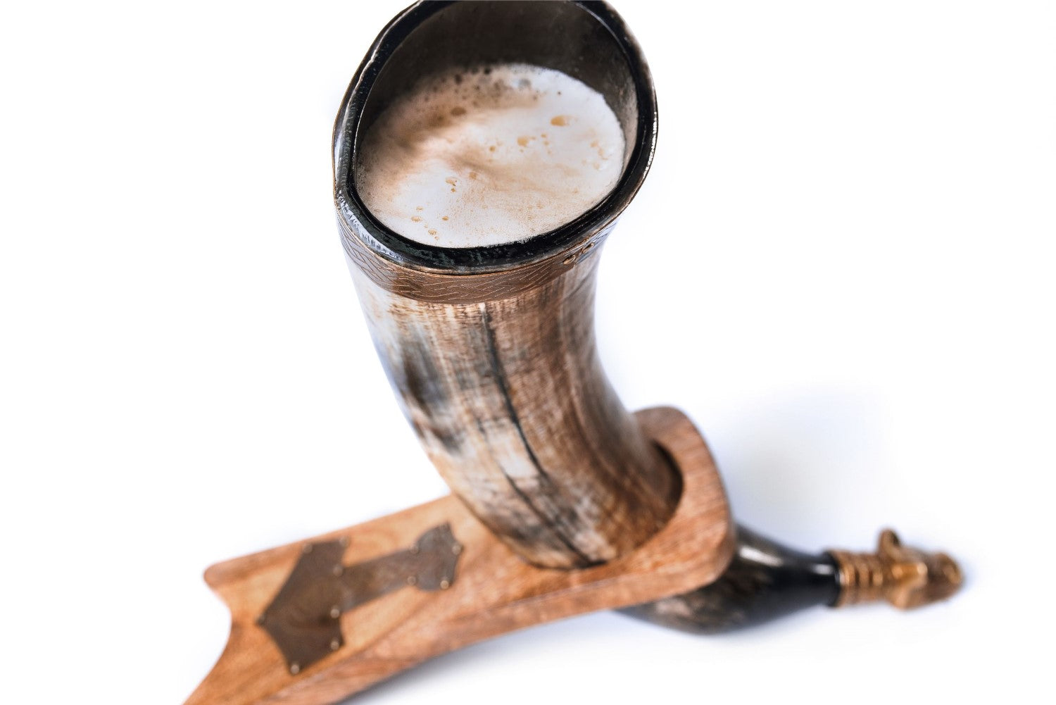 Horn-shaped mug with wooden handle filled with a frothy beverage on a white background