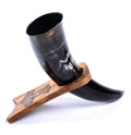 Black horn cup with wooden holder on a white background