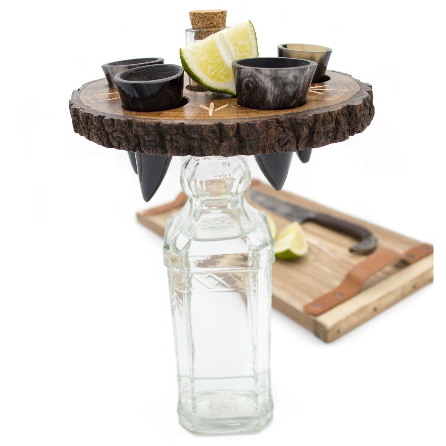 Wooden drink tray with shot glasses, lime wedges, and a bottle on a white background