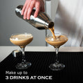FANCY MAN Insulated Cocktail Shaker pouring drinks into two glasses, perfect for making up to 3 drinks at once.