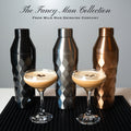 FANCY MAN Insulated Cocktail Shaker collection with cocktails and shakers on a black mat.