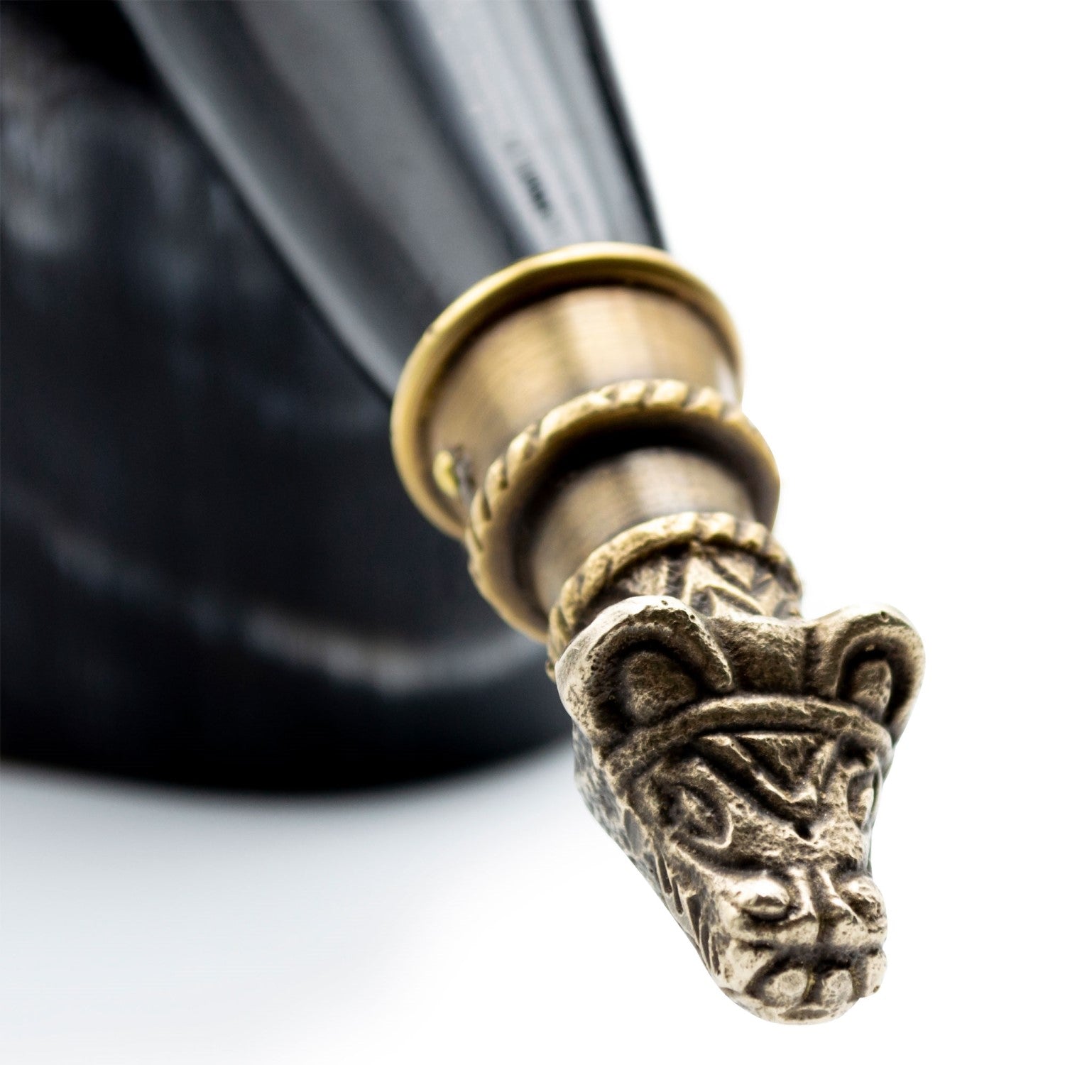 Decorative pen cap with intricate design on a white background