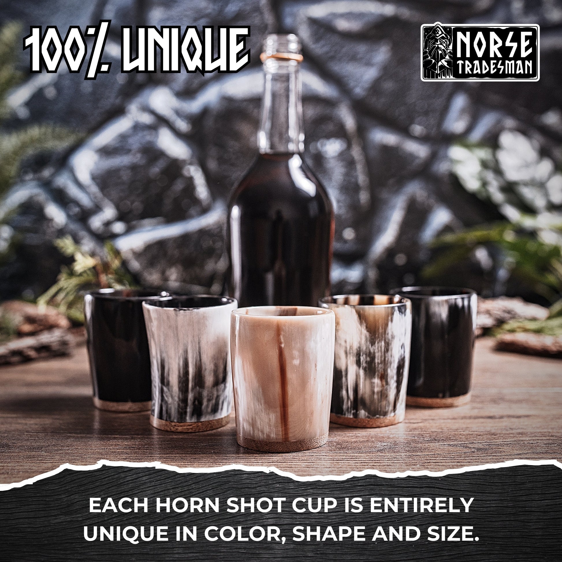 Horn shot cups and a bottle on a wooden surface with a stone wall background, featuring the Norse Tradesman brand.