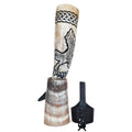 Decorative horn with wolf design and black strap on a white background