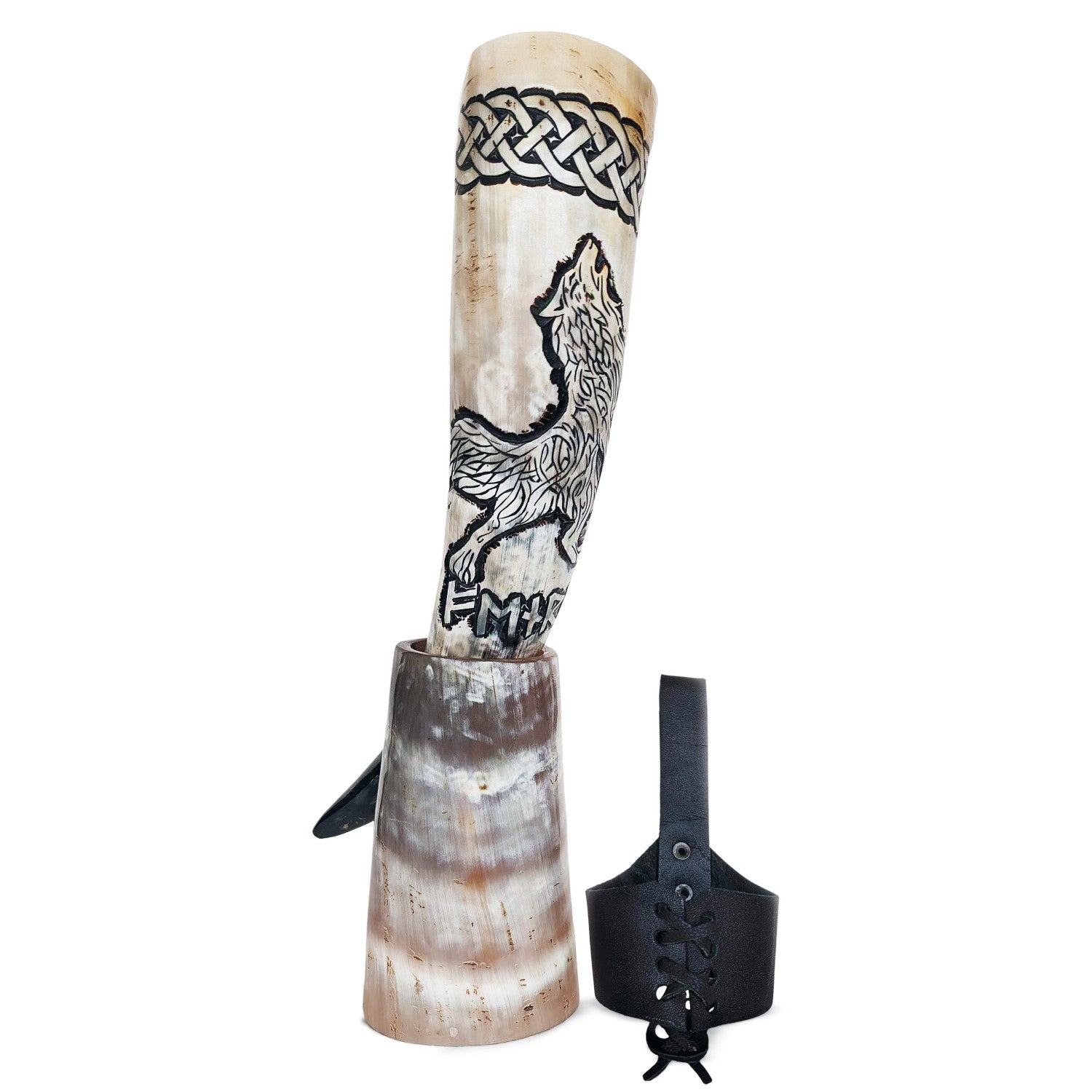 Decorative horn with wolf design and black strap on a white background