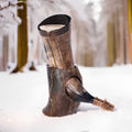 Wooden boot with a decorative element in a snowy forest setting