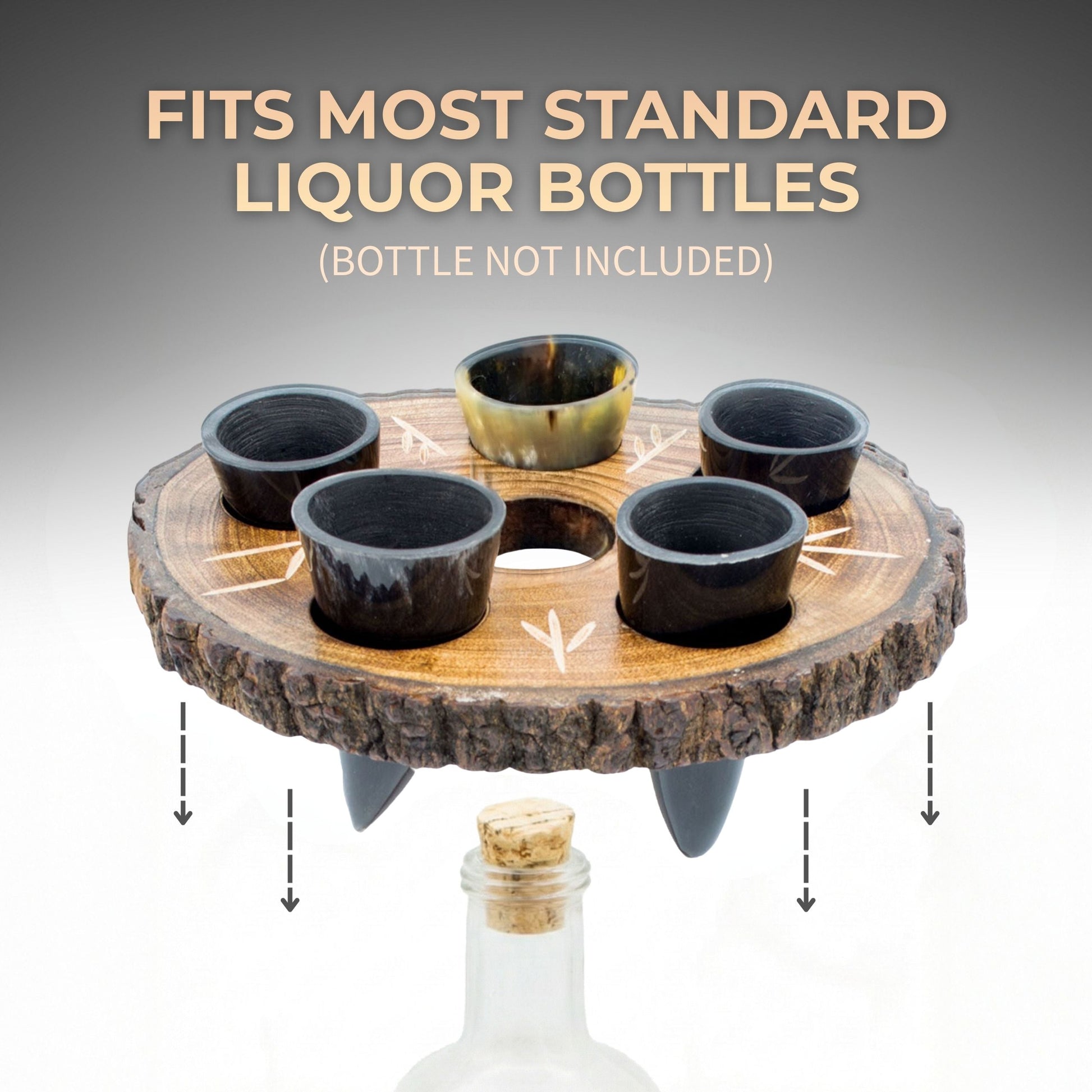 Wooden bottle holder with five shot glasses on a gray background