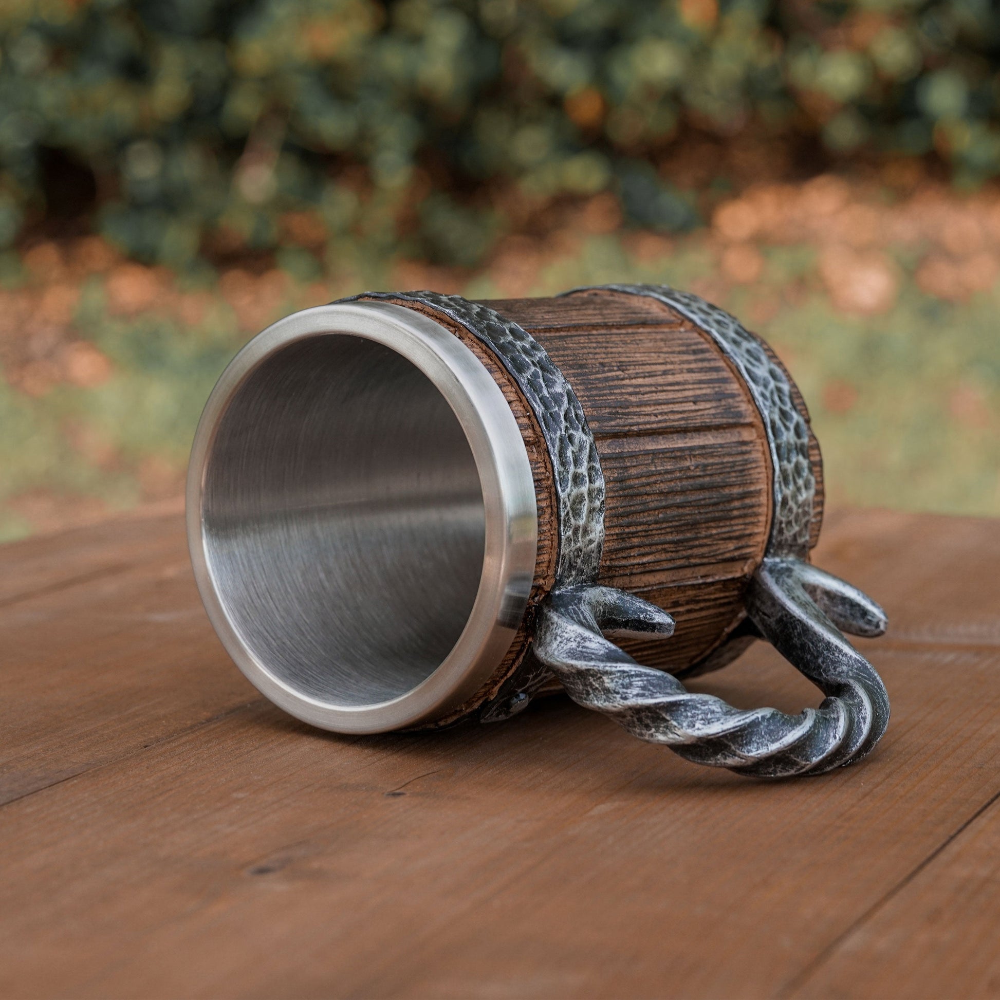 Wooden cup with metal accents on a wooden surface